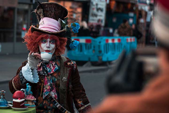 Clown artist sipping coffee while managing his clown business with MyBizzHive's clown business management CRM