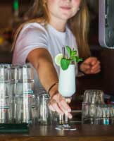 Bartenders CRM software A girl serving wine is very happy with CRM for bartenders