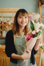 The florist girl is efficiently doing work with MyBizzHive’s CRM for florist